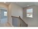 Staircase with wood and iron railing and a window for natural light at 128 Dalston Cv, Stockbridge, GA 30281
