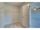 The walk-in closet offers carpet and wire shelving for organization and storage at 128 Dalston Cv, Stockbridge, GA 30281