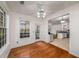 Dining area with hardwood floors, multiple windows, and an open view to the kitchen at 11300 Musette Cir, Alpharetta, GA 30009