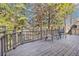 Back deck of home with railing and outdoor seating overlooking a wooded area at 1883 Rugby Ave, Atlanta, GA 30337