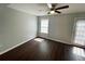 Bright bedroom with a ceiling fan, luxury vinyl plank floors, and a door to the exterior at 5642 Feldwood Rd, Atlanta, GA 30349