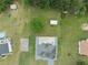 Sprawling backyard from above, revealing a pool, outbuildings, and lush landscaping surrounding a well-maintained home at 709 Mohansic Ave, Loganville, GA 30052