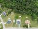 Expansive aerial view showcasing a home nestled on a wooded lot, complete with a pool and ample space at 709 Mohansic Ave, Loganville, GA 30052