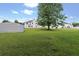 Lush green backyard with a large tree and plenty of open space, perfect for outdoor activities and relaxation at 709 Mohansic Ave, Loganville, GA 30052