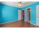 Bedroom featuring a ceiling fan, neutral decor, multiple doors, and hardwood floors at 709 Mohansic Ave, Loganville, GA 30052