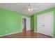 Cozy bedroom with closet space and hardwood floors and bright green accent wall at 709 Mohansic Ave, Loganville, GA 30052
