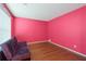 Bedroom features hardwood floors, and natural light from a large window at 709 Mohansic Ave, Loganville, GA 30052