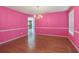 Dining room featuring hardwood floors, elegant lighting fixture, and large window with natural light at 709 Mohansic Ave, Loganville, GA 30052