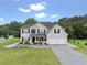 Attractive two-story home with a two-car garage, professional landscaping, and a well-manicured lawn at 709 Mohansic Ave, Loganville, GA 30052