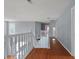 Upper hallway with hardwood floors, white bannister and trim and multiple windows at 709 Mohansic Ave, Loganville, GA 30052