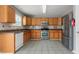 Modern kitchen with stainless steel appliances, granite countertops, and hardwood cabinets at 709 Mohansic Ave, Loganville, GA 30052