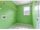Laundry room with overhead shelving and tiled floor at 709 Mohansic Ave, Loganville, GA 30052