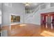 Living room featuring hardwood floors, high ceilings, staircase, and kitchen access at 709 Mohansic Ave, Loganville, GA 30052