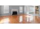 Spacious living room featuring hardwood floors, fireplace, and abundant natural light at 709 Mohansic Ave, Loganville, GA 30052