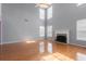 Bright living room with hardwood floors, tall ceilings, fireplace, and large windows at 709 Mohansic Ave, Loganville, GA 30052