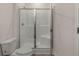 Bathroom with a glass-enclosed shower and a toilet, designed for convenience and style at 8592 Secretariat Dr, Lithonia, GA 30058