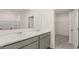 The bright bathroom features double sinks with a white countertop, complemented by a large mirror at 8592 Secretariat Dr, Lithonia, GA 30058