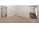 Carpeted bedroom with neutral walls and trim, offering access to both a bathroom and living areas at 8592 Secretariat Dr, Lithonia, GA 30058