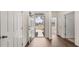 View of the entryway shows natural light, beautiful wood floors, and access to the home's interior at 8592 Secretariat Dr, Lithonia, GA 30058