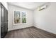 A bedroom with natural lighting, hardwood style floors and a closet with dark doors at 1106B Wedgewood Nw Dr, Atlanta, GA 30318