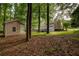 Large backyard with a storage building, mature trees, and an expansive deck at 1261 William Robert Sw Dr, Marietta, GA 30008