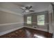 Cozy room with hardwood floors, a ceiling fan, and natural light from two windows at 1261 William Robert Sw Dr, Marietta, GA 30008