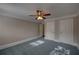 Bedroom with neutral paint, carpet, crown moulding, ceiling fan with light and closet at 1261 William Robert Sw Dr, Marietta, GA 30008