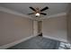 Bedroom with plush blue carpeting, ceiling fan, and window at 1261 William Robert Sw Dr, Marietta, GA 30008