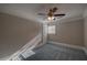 Bedroom with plush blue carpeting, ceiling fan, and window at 1261 William Robert Sw Dr, Marietta, GA 30008