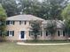 Traditional two-story home boasts black shutters, mature trees, and a classic front door at 1261 William Robert Sw Dr, Marietta, GA 30008