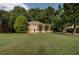 Traditional two-story home with mature trees sits on a spacious green lawn at 1261 William Robert Sw Dr, Marietta, GA 30008