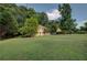 Expansive front yard with lush green lawn and a well-maintained home with mature trees at 1261 William Robert Sw Dr, Marietta, GA 30008