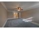 Main bedroom with neutral paint, carpet, crown moulding, ceiling fan with light and bathroom access at 1261 William Robert Sw Dr, Marietta, GA 30008