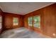 Versatile room with wood paneling, two windows and neutral tiled flooring at 1261 William Robert Sw Dr, Marietta, GA 30008