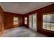 Functional room with wood paneling, tiled floor and multiple windows that bring in natural light at 1261 William Robert Sw Dr, Marietta, GA 30008