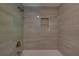 Tiled shower with bronze shower head and built in shampoo nook at 1261 William Robert Sw Dr, Marietta, GA 30008