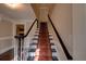 Classic staircase with a carpet runner and dark wood railing in a neutrally decorated home at 1261 William Robert Sw Dr, Marietta, GA 30008