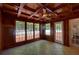 Cozy sunroom featuring wood paneled walls and ceiling and tile floors at 1261 William Robert Sw Dr, Marietta, GA 30008
