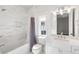 Clean bathroom featuring marble tile surround, bathtub, and a vanity with elegant fixtures at 229 Dovecrest Nw Dr, Atlanta, GA 30305