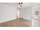 Bright bedroom with wood floors featuring ensuite bath and a ceiling fan for optimal comfort at 229 Dovecrest Nw Dr, Atlanta, GA 30305