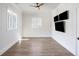 Well-lit bedroom with wood floors and recessed lighting, featuring three televisions on one wall at 229 Dovecrest Nw Dr, Atlanta, GA 30305
