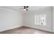 Minimal bedroom with hardwood floors, large window, and white trim at 229 Dovecrest Nw Dr, Atlanta, GA 30305