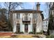 Elegant stone home featuring a charming balcony and manicured front lawn at 229 Dovecrest Nw Dr, Atlanta, GA 30305