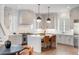 Bright kitchen with stainless steel appliances, large island with seating, and stylish pendant lighting at 229 Dovecrest Nw Dr, Atlanta, GA 30305