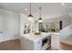 Kitchen island with seating and prep sink, leading to an outdoor fireplace and living area at 229 Dovecrest Nw Dr, Atlanta, GA 30305