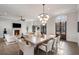 Open-concept living and dining area with a fireplace, modern decor, and hardwood floors at 229 Dovecrest Nw Dr, Atlanta, GA 30305
