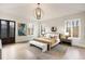 Light-filled main bedroom with large windows, decorative lighting, and hardwood floors at 229 Dovecrest Nw Dr, Atlanta, GA 30305