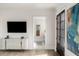Bedroom with mounted TV, connecting door to bath, and neutral decor at 229 Dovecrest Nw Dr, Atlanta, GA 30305