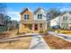 Charming duplex featuring a welcoming front porch and colorful doors, complemented by a manicured lawn at 1106A Wedgewood Nw Dr, Atlanta, GA 30318