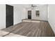 Spacious living room with dark hardwood floors, a modern ceiling fan, and natural lighting at 1106A Wedgewood Nw Dr, Atlanta, GA 30318